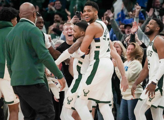 Milwaukee Bucks forward Giannis Antetokounmpo (34) celebrates Milwaukee Bucks guard Damian Lillard (0) as he made the game winning three during their game against the Sacramento Kings Sunday, Jan. 14, 2024, at Fiserv Forum in Milwaukee. The Milwaukee Bucks won 143-142 in overtime over the Sacramento Kings. Ebony Cox / Milwaukee Journal Sentinel