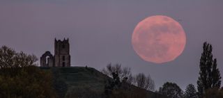 the bright full moon in the night sky