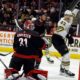 Boston Bruins' Danton Heinen (43) celebrates after his goal near Carolina Hurricanes goaltender Frederik Andersen (31), Brett Pesce (22) and Jake Guentzel (59) during the first period of an NHL hockey game in Raleigh, N.C., Thursday, April 4, 2024.