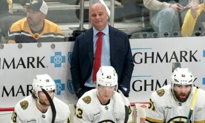 Boston Bruins head coach Jim Montgomery stands behind his bench during the third period of an NHL hockey game against the Pittsburgh Penguins, Saturday, April 13, 2024, in Pittsburgh.