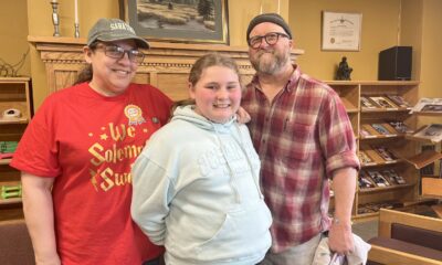 McKenna and her parents at the Massena Public Library. Photo: Monica Sandreczki