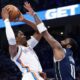 The Oklahoma City Thunder's Jalen Williams goes up for a basket as the Dallas Mavericks' Kyrie Irving (11) defends.