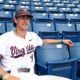 Portrait of Henry Ford in his UVA baseball jersey sitting in the stands