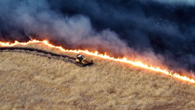 A bulldozer drives along the Corral Fire line in California on Sunday, June 2, 2024.