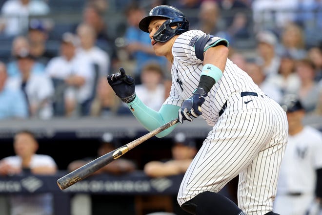 Jun 7, 2024; Bronx, New York, USA; New York Yankees right fielder Aaron Judge (99) follows through on a double against the Los Angeles Dodgers during the first inning at Yankee Stadium. Mandatory Credit: Brad Penner-USA TODAY Sports