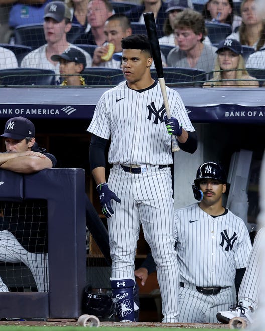 Jun 7, 2024; Bronx, New York, USA; New York Yankees right fielder Juan Soto (22) holds a bat on the top step of the dugout during the seventh inning against the Los Angeles Dodgers at Yankee Stadium. Mandatory Credit: Brad Penner-USA TODAY Sports