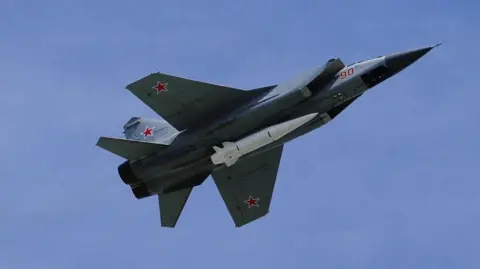 Getty Fighter jet with Kinzhal hypersonic missile on its underside, pictured against blue sky