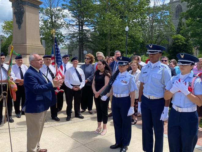 Paul Ferreira, left, president of The Greater Taunton Area Day of Portugal Committee, gives the opening remarks for the flag raising ceremony outside Taunton City Hall on Saturday, June 8 2024.