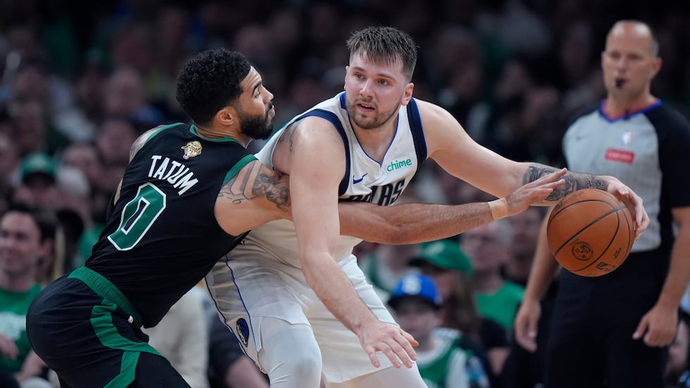 Boston Celtics forward Jayson Tatum (0) pressures Dallas Mavericks guard Luka Doncic, front...