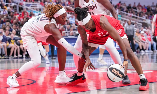 Indiana Fever guard Erica Wheeler (17) scrambles for the ball against Atlanta Dream guard Rhyne Howard (10) on Thursday, June 13, 2024, during the game at Gainbridge Fieldhouse in Indianapolis.