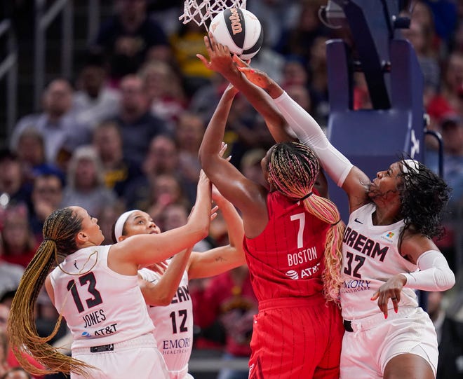 Indiana Fever forward Aliyah Boston (7) goes in for a lay-up against Atlanta Dream forward Cheyenne Parker-Tyus (32) and Atlanta Dream guard Haley Jones (13) on Thursday, June 13, 2024, during the game at Gainbridge Fieldhouse in Indianapolis. The Indiana Fever defeated the Atlanta Dream, 91-84.