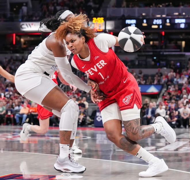 Indiana Fever forward NaLyssa Smith (1) rushes up the court against Atlanta Dream forward Cheyenne Parker-Tyus (32) on Thursday, June 13, 2024, during the game at Gainbridge Fieldhouse in Indianapolis.