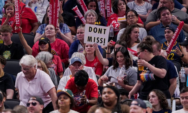 An Indiana Fever fan holds up a sign Thursday, June 13, 2024, during the game at Gainbridge Fieldhouse in Indianapolis. The Indiana Fever defeated the Atlanta Dream, 91-84.