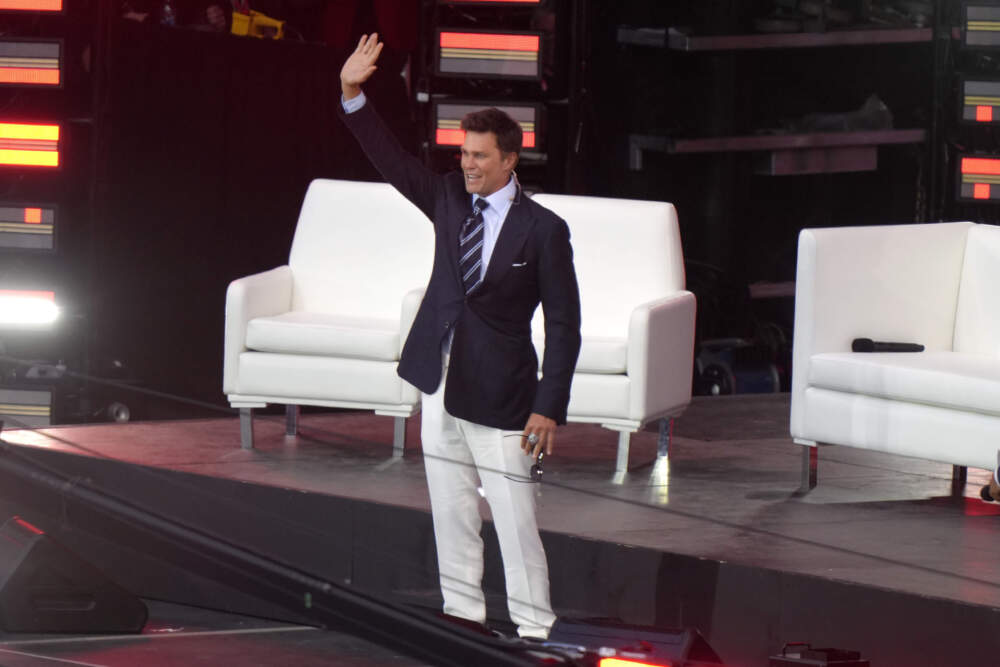 Former New England Patriots quarterback Tom Brady waves as he takes the stage at the Patriots Hall of Fame induction ceremony at Gillette Stadium, Wednesday, June 12, 2024, in Foxborough, Mass. (Steven Senne/AP)