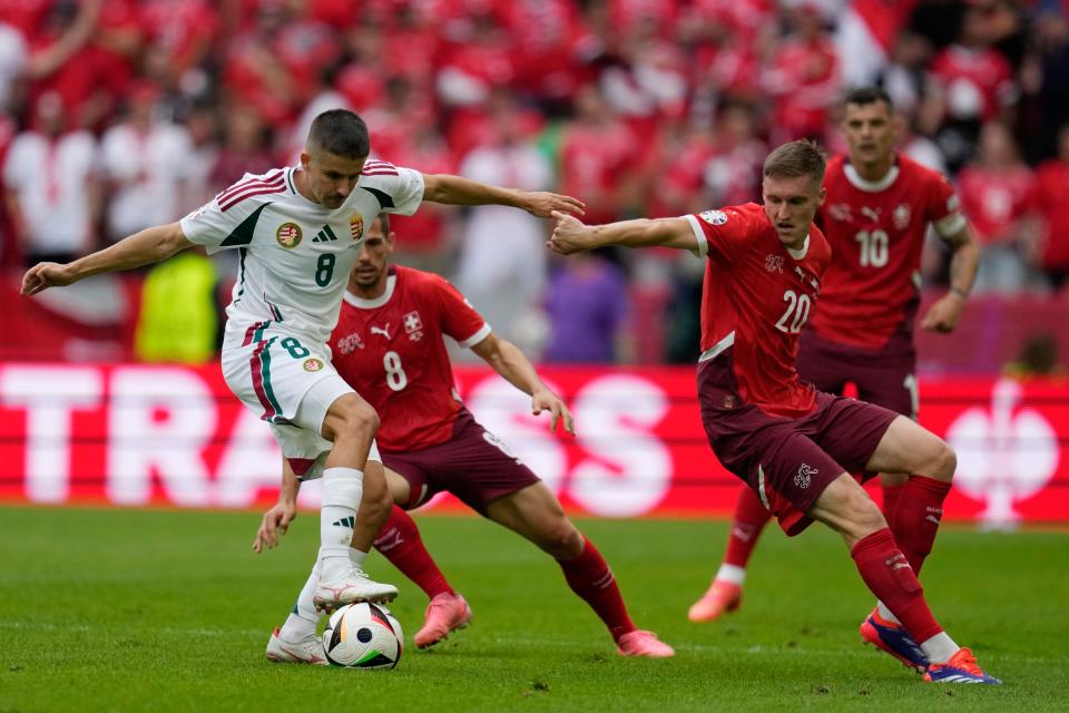 Hungary's Adam Nagy, left, challenges for the ball with Switzerland's Michel Aebischer (AP)