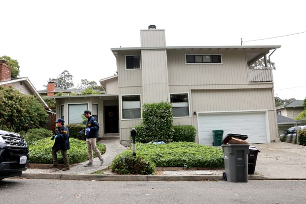 FBI agents exit the house associated with Oakland Mayor Sheng...