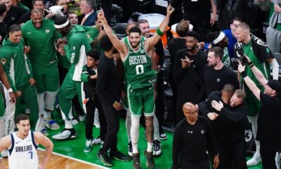 Jayson Tatum celebrates with the Celtics bench.