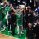 Jayson Tatum celebrates with the Celtics bench.