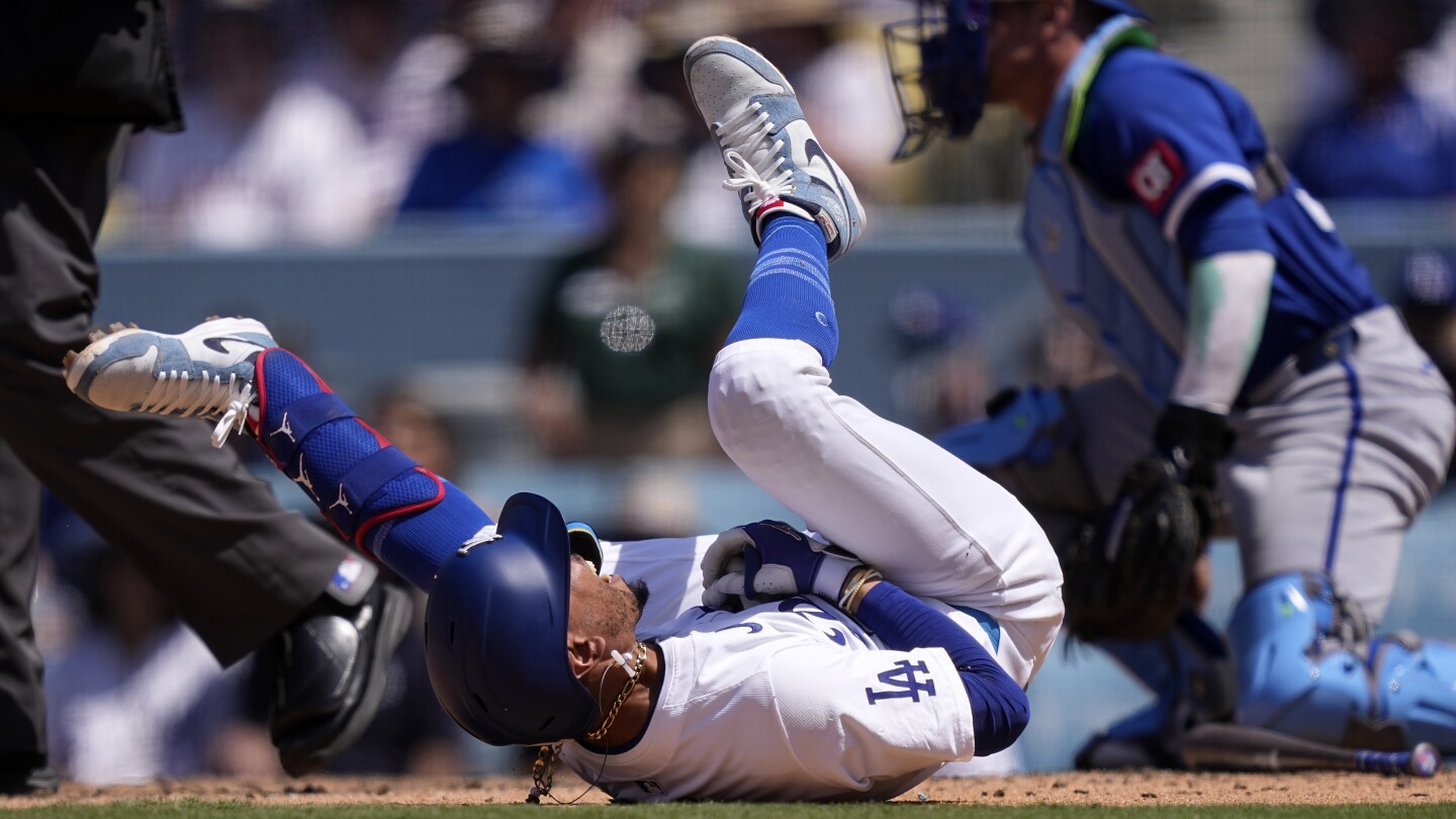 Dodgers star Mookie Betts suffers broken left hand when hit by a pitch