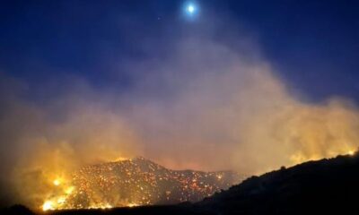 The moon shines over the Post Fire early Sunday, June 16, 2024, burning between Gorman and Pyramid Lake.