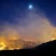 The moon shines over the Post Fire early Sunday, June 16, 2024, burning between Gorman and Pyramid Lake.