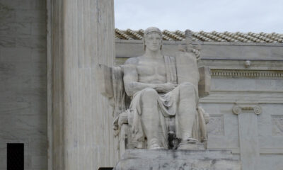 The statute of a seated man outside the Supreme Court