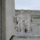 The statute of a seated man outside the Supreme Court