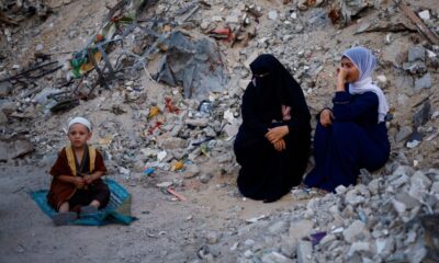 Palestinians hold Eid al-Adha prayers by the ruins of al-Al Rahma mosque destroyed by Israeli air strikes, in Khan Younis,...