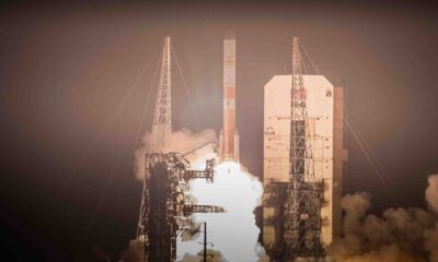 Flames and smoke billow from underneath a rocket as it lifts off from a launch pad.