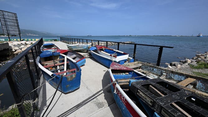 Boats are pictured tied up to a fence at the Kingston Waterfront ahead of Hurricane Beryl in Kingston, Jamaica, on July 2, 2024.