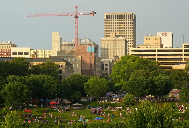 July 3, 2024; Columbus, Ohio, USA; 
People set up along the east bank of the Scioto River to spectate before the Red, White and Boom fireworks in downtown Columbus.