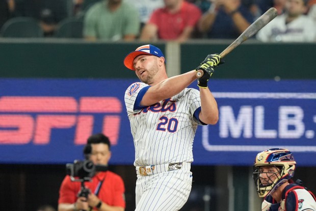 The New York Mets’ Pete Alonso follows through during the...