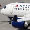 Some airline issues continued Monday after a faulty software update caused technological havoc worldwide and resulted in several carriers grounding flights, but the number of flights impacted is declining. Here, a Delta Air Lines jet leaves the gate on Friday at Logan International Airport in Boston.