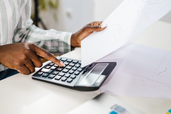 calculator and holding a paper