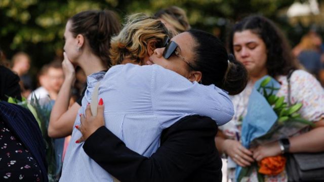 Two people hug as they attend a vigil for the victims of Monday's attack in Southport