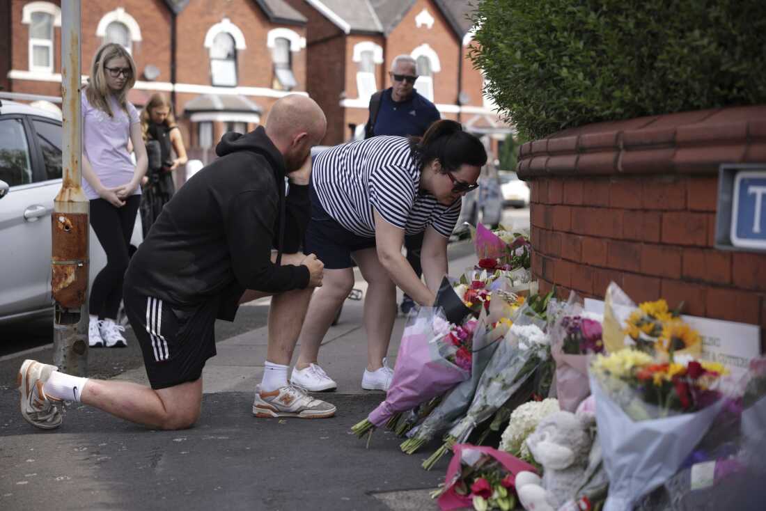 People on Tuesday leave flowers near the scene of a deadly knife attack at a dance school on Monday, in Southport, England.