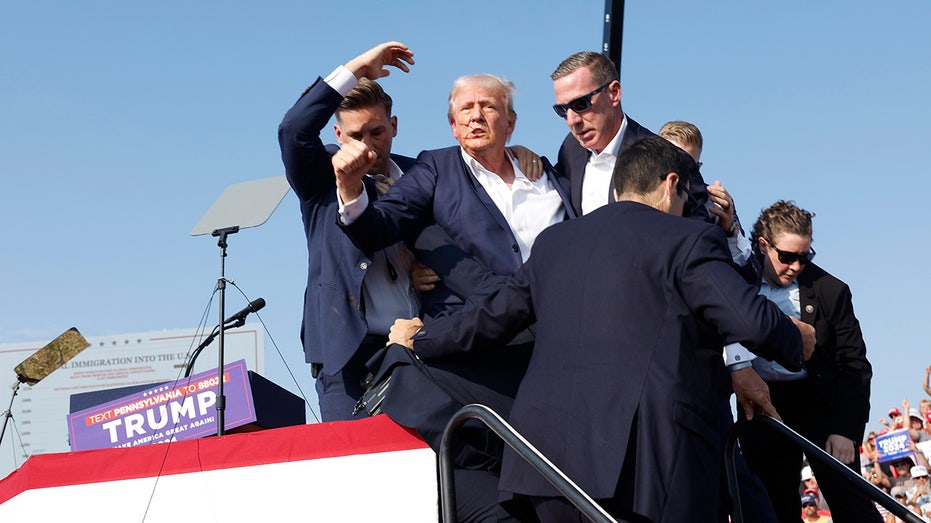 Donald Trump is rushed offstage during a rally