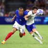 France's Kiliann Sildillia (left) is challenged by the USA's Paxten Aaronson in the opening game of group play on Wednesday at the 2024 Summer Olympics in Marseille, France.