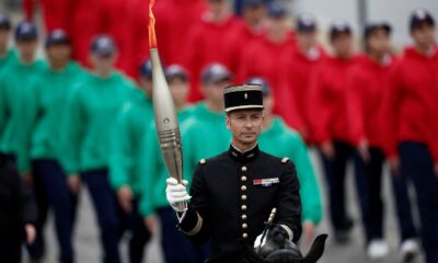 Olympic flame arrives in Paris, at the center of Bastille Day parade