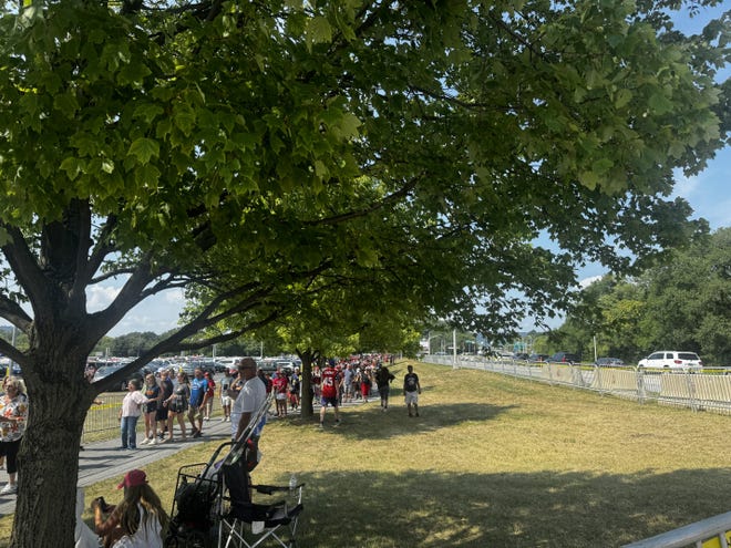 A long line of people wait to enter the New Holland Arena for the Trump rally July 31, 2024.