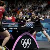 Rachel Sung and Amy Wang of the U.S. women's table tennis team take on Germany during the 2024 Olympic Games in Paris. at the South Paris Arena in Paris on August 6, 2024. (Photo by WANG Zhao / AFP) (Photo by WANG ZHAO/AFP via Getty Images)