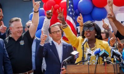 Philadelphia Mayor Cherelle Parker (right) raises a finger for one Philadelphia, united, next to Pennsylvania Gov. Josh Shapiro in July.