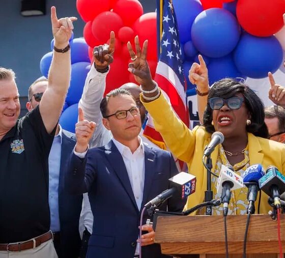 Philadelphia Mayor Cherelle Parker (right) raises a finger for one Philadelphia, united, next to Pennsylvania Gov. Josh Shapiro in July.