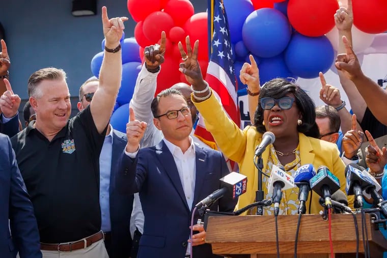 Philadelphia Mayor Cherelle Parker (right) raises a finger for one Philadelphia, united, next to Pennsylvania Gov. Josh Shapiro in July.