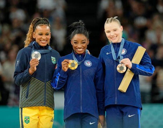 Rebeca Andrade of Brazil, Simone Biles and Jade Carey of the United States pose for a photo during the medal ceremony for the vault on the first day of gymnastics event finals during the Paris 2024 Olympic Summer Games at Bercy Arena.