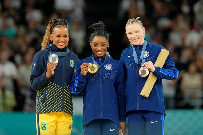 Rebeca Andrade of Brazil, Simone Biles and Jade Carey of the United States pose for a photo during the medal ceremony for the vault on the first day of gymnastics event finals during the Paris 2024 Olympic Summer Games at Bercy Arena.