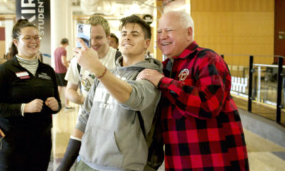 Minnesota Gov. Tim Walz has his photo taken with young fans.